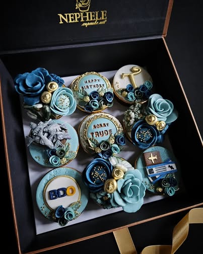 Nephele Cupcake Art classic collection — elegant blue and gold birthday cupcakes with handcrafted roses